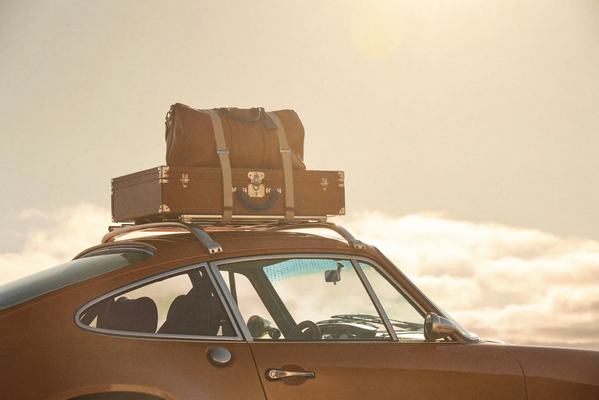 Bespoke Louis Vuitton trunks mounted on the roof rack of the Singer Classic
